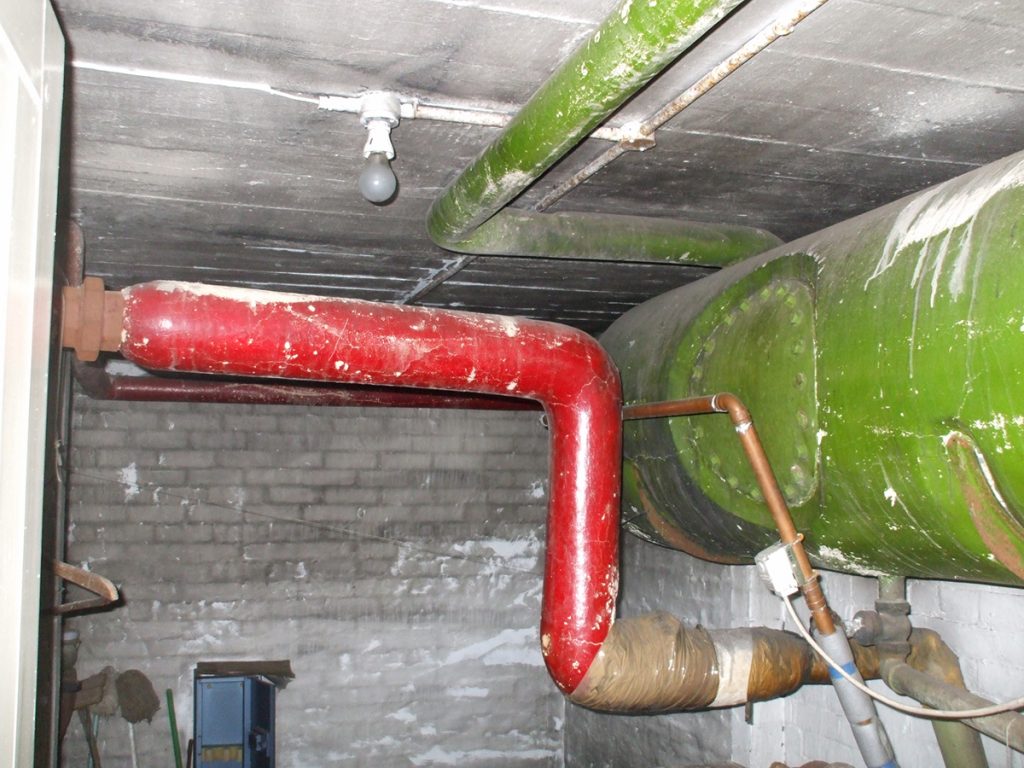 Painted red, this image is of asbestos lagging around heating pipes