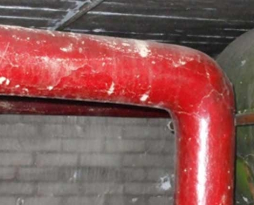 Painted asbestos lagging around a pipe